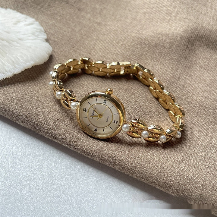 Montre-bracelet pour femme avec bracelet métallique et perles